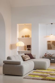 a living room filled with furniture and white walls