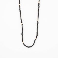 This beautiful Obsidian Beaded Necklace is edgy. elegant, and eye-catching, making it perfect for wearing by itself or layered with a simple chain necklace. The strand of pearls is punctuated with your choice of gold or silver beads for added interest. Note: We reinforce the necklace’s center silk cord with hidden knots—if your necklace breaks, most of the beads will remain intact and unaffected. For maximum life, we recommend you do not wear this necklace in water or during any rigorous activit Minimalist Single Strand Necklaces For Layering, Everyday Beaded Chain Necklace With Round Beads, Minimalist Beaded Chain Necklace With Round Beads, Minimalist Single Strand Necklace With Round Beads, Minimalist Everyday Pearl Necklace With Beaded Chain, Everyday Round Gemstone Beads Necklace, Everyday Minimalist Pearl Necklace With Beaded Chain, Minimalist Polished Bead Necklace For Everyday, Adjustable Minimalist Pearl Necklace With Beaded Chain