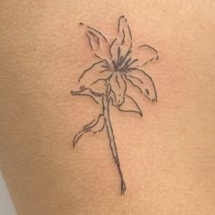 a flower tattoo on the back of a woman