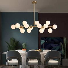 a dining room table with four chairs and a chandelier hanging from the ceiling