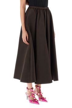 VALENTINO midi skirt crafted in heavyweight technical duchesse, characterized by a flared fit featuring elastic drawstring waistband and silk-lined side inseam pockets. The model is 177 cm tall and wears a size IT 40. Size Info IT Color Detail Brown Made In Italy Material 82%PL 18%SE Season One spring Season Two summer Product clothing Brand Valentino Size And Fit