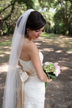 a woman in a wedding dress holding a bouquet