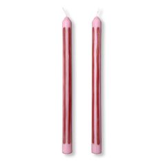 two pink candles sitting next to each other