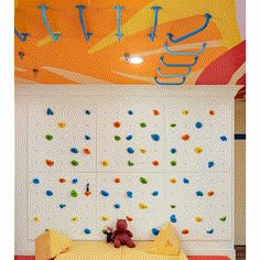 a child's bedroom with climbing walls and toys