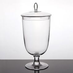 an empty glass with a lid sitting on a table