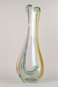 a multicolored glass vase sitting on top of a table