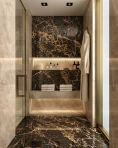 a bathroom with marble walls and flooring next to a walk - in shower area