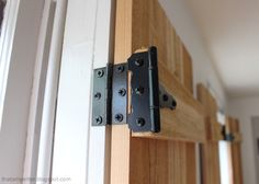 an image of a wooden door handle on the side of a house with wood trim