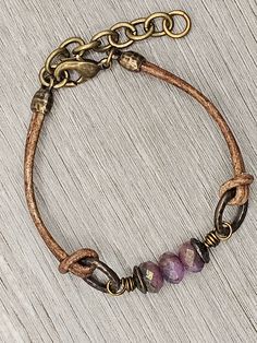 Czech Glass Purple Sapphire Blue Mix beads with antique brass accents on antique brown leather bracelet.  This bracelet has a size fit of approximately 7 inches to 7 1/2 inches. To keep beads, leather and all other components looking their best, avoid contact with water, lotions and perfumes. To access all other items in my shop, just hit the link here: https://www.etsy.com/ca/shop/KootenayLeatherRHS If you like jewelry, check out my other Etsy shop...it's jewelry for your door!  www.etsy.com/ca Antique Brown Bracelet Ideal For Gifts, Antique Brown Bracelet Gift, Everyday Vintage Jewelry With Leather Strap, Vintage Leather Strap Jewelry For Everyday, Handmade Brown Brass Bracelet, Adjustable Vintage Bracelets, Adjustable Bohemian Bracelet With Antique Finish, Vintage Leather Jewelry With Waxed Finish, Vintage Adjustable Jewelry With Leather Strap