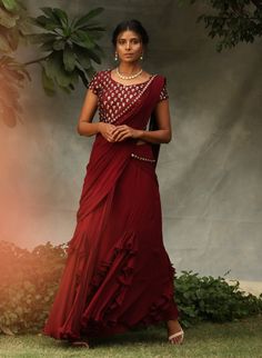 Editor's Note Blouse Is Embellished With Stone Work Maroon Drape Saree Set Fabric: Georgette And Silk Color: Maroon Care: Dry Clean Only About the Designer Nidhika Shekhar Label Is an Exclusive Designer Wear For Women Which Was Launched In 2014. The Label Is A Perfect Amalgamation Of Indian Aesthetics Incorporated In Unique Silhouettes. Their Main Area Of Focus Is Designing Which Fits/suits The Client And They Are Known For The Unique Silhouettes In The Industry. Embellished Georgette Saree For Celebration, Embellished Pre-draped Georgette Saree For Celebration, Celebration Embellished Georgette Saree, Embellished Semi-stitched Saree For Navratri, Embellished Semi-stitched Pre-draped Saree For Navratri, Festive Embellished Saree For Celebration, Embellished Anarkali Pre-draped Saree For Navratri, Embellished Saree For Celebration With Traditional Drape, Floor-length Embellished Pre-draped Saree In Chinon