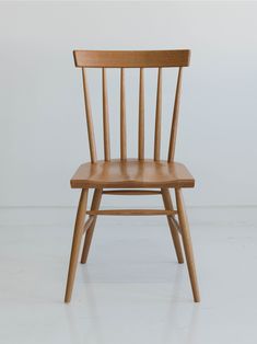 a wooden chair sitting on top of a white floor