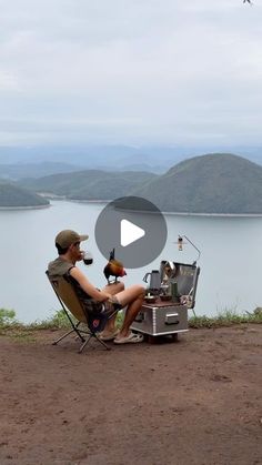 a man sitting in a chair with a dog on his lap next to an open camp stove