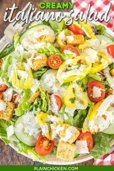 a salad with cheese, tomatoes and cucumber in it on a checkered table cloth