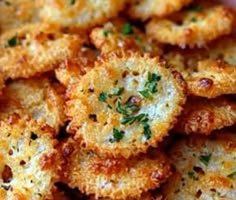 some fried food is on a plate with parmesan cheese and seasoning sprinkles