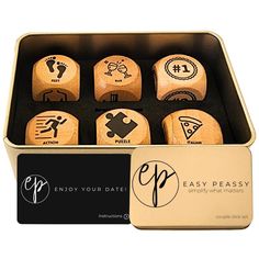 six wooden dices in a tin with the words enjoy your date printed on them