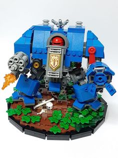 a blue lego robot is on the ground