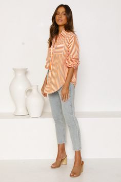 Detail: Button-down shirt Striped print Longline shirt Regular fit Size Available: Top Size Shoulder Bust Length Sleeve Length inch cm inch cm inch cm inch cm S 24¼ 63 35½ 90 28 71 22½ 57 M 25 64 37¼ 94 29¾ 75 23 58 L 25½ 65 38¾ 98 31¼ 79 23¼ 59 XL 26 66 40¼ 102 32¾ 83 23¾ 60 Trendy Orange Long Sleeve Shirt, Casual Orange Shirt For Workwear, Casual Orange Shirt For Work, Orange Button-up Shirt With Pockets, Orange Long Sleeve Shirt With Pockets, Casual Orange Collared Blouse, Casual Collared Orange Blouse, Trendy Orange Shirt For Work, Trendy Orange Shirt With Buttons