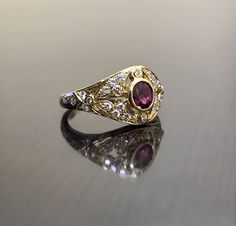 DeKara Designs Collection Metal- 18K Yellow Gold, .750. Stones- 1 Oval Ruby 0.50, 28 Round Diamonds G Color VS2 Clarity 0.22 Carats. Art Deco 18K Yellow Gold Ruby Diamond Engagement Ring. This ring features a beautiful reddish pink ruby that is half carat total weight, surrounded by 28 round diamonds. The center ruby is bezel set, 20 pave set diamonds, and 8 bezel set diamonds. The ring is entirely handmade, and could be hand engraved for an additional $200.00. The ring is a size 6 1/2, and coul Exquisite Yellow Gold Ruby Wedding Ring, Exquisite Yellow Gold Ruby Ring For Wedding, Traditional Yellow Gold Ruby Ring For Anniversary, Exquisite Gold Ruby Ring With Center Stone, Exquisite Gold Ruby Wedding Ring, Exquisite Gold Ruby Ring For Wedding, Traditional Gold Rings With Center Stone, Luxury Gold Ruby Ring With Single Cut Diamonds, Gold Ruby Wedding Ring With Halo Setting