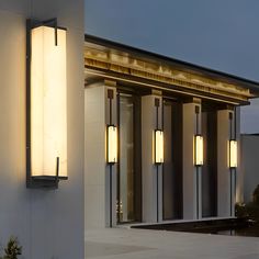 an exterior view of a modern building with lights on the outside and in the front