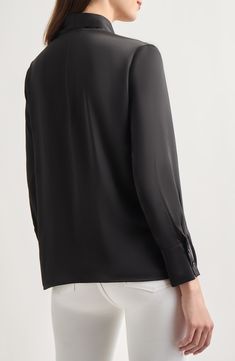 This tie-neck blouse made from  lightweight crêpe de chine is a perfect workday option. Ties at neck Long sleeves 100% polyester Hand wash, line dry Imported Sleek Silk Blouse For Work, Sleek Silk Workwear Blouse, Sleek Tops With Concealed Placket For Work, Sleek Viscose Office Blouse, Chic Long Sleeve Silk Crepe Tops, Black Tie Neck Blouse For Work, Sleek Viscose Tops For Office, Viscose Tie Neck Top For Work, Tie Neck Viscose Tops For Workwear