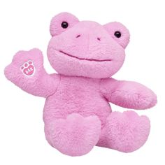 a pink stuffed animal with paw prints on it's chest and eyes, sitting upright