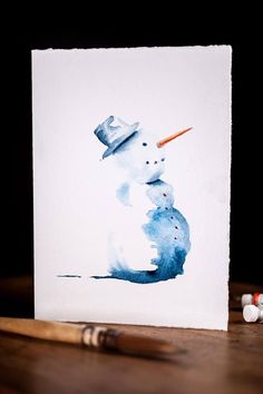 a watercolor painting of a snowman with a hat on