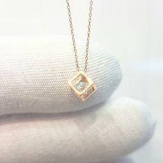 - Cube pendant necklace is made with high-quality 14K real solid gold. - The Inside of the cube, there is a diamond cut cubic zirconia stone and it is moving. - The dimensions of the cube is 0.5 X 0.5 X 0.5 cm. - This dainty, charm, tiny, delicate, cute and trendy pendant necklace has been artfully designed for timeless yet modern millennial fashion. - This 14K solid gold pendant comes with a beautiful matching free 14K real solid gold chain. - You receive the pendant in a beautiful and free gif Diamond Clavicle Chain Charm Necklace As Gift, Cubic Zirconia Square Pendant Necklace For Gifting, 14k Gold Square Pendant Necklace With Birthstone, 14k Rose Gold Square Pendant Jewelry, Rose Gold Square Pendant Necklace For Anniversary, Gift Diamond Necklace With Square Pendant, Square Pendant Solitaire Necklace With Diamond Cut For Gift, Fine Jewelry Solitaire Necklace With Square Pendant As Gift, Diamond Cut Solitaire Necklace With Square Pendant For Gifts