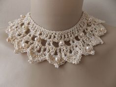 a white crocheted necklace with pearls