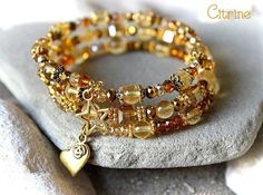 Citrine Bracelet, Citrine Wrapped Bracelet, Citrine and Gold Bracelet, Citrine Jewelry, Yellow Bead Bracelet, Citrine Multistrand Bracelet, Citrine Cuff Bracelet, Birthstone Bracelet, November Bracelet Gorgeous energy bracelet made of 6 mm. Citrine beads, gold crystals and gold plated components. The beads are strung on hard memory wire in 3 rows. This bracelet is adjustable. See the last photo and choose your size spiral wire with the option. ♥ Unique design & handmade product by MimosaMile Yellow Bead Bracelet, Multistrand Bracelet, Chakra Heilung, November Birthstone Jewelry, Gold Crystals, Citrine Bracelet, Citrine Jewelry, Citrine Beads, Energy Bracelets