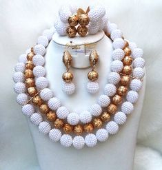 White with Gold Balls Wedding Bridal Party African Nigerian Beads Jewelry Set Complete Set is Necklace Earring and bracelet **Beads is acrylic  Wedding Party Bridal Special Occasion This detailed Jewellery set makes you stand out elegantly in any special occasion, it's all about glamour and uniqueness.  Buying more than 1 Jewellery set, we offer wholesale and bulk prices for all our jewellery. Festive White Pearl Jewelry Sets, White Crystal Bridal Sets For Party, White Beaded Jewelry Sets For Celebration, White Pearl Jewelry For Celebration, White Pearl Jewelry With Silver Beads, Party Pearl White Beaded Bracelets With Round Beads, Party White Beaded Necklaces With Colorful Beads, Party Bridal Necklace With Polished Round Beads, White Pearl Bridal Necklace For Celebration