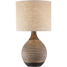 a table lamp with a beige shade on the base and a brown, circular design