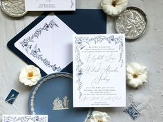 the wedding stationery is laid out on top of each other, including an envelope