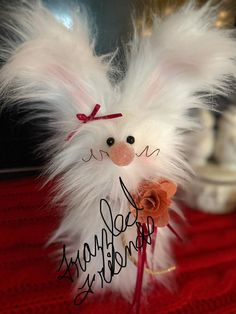 a white stuffed animal with a happy birthday message on it's head and handwritten name