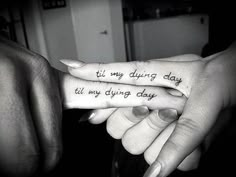 two people holding each other's hands with tattoos on their fingers that say i'm my dying day