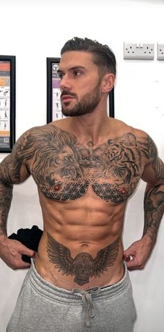 a man with tattoos on his chest and arms