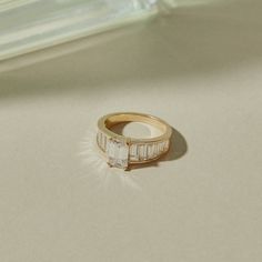 a diamond ring sitting on top of a table