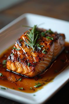 Grilled salmon fillet garnished with fresh rosemary and chives in a savory sauce. Orange Maple Glazed Salmon, Maple Balsamic Salmon, Glazed Fish Recipes, Sweet Chili Glazed Salmon, Healthy Fish Recipes Salmon, Fall Salmon Recipes Baked, Maple Pecan Salmon Recipes, Maple Glaze For Salmon, Maple Salmon Marinade