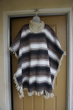 "Vintage cape - not sure of the material but its soft thick and warm. Condition - good but can use a cleaning. Measurements taken across front laid flat 43\" across 37\" length" One Size Wool Poncho Cape, Wool Cape Poncho One Size, Wool Poncho Cape One Size, Brown Wool Cape For Winter, Beige Hooded Poncho For Fall, Brown Winter Cape For Cold Weather, Brown Winter Cape, Oversized Brown Cape Shawl, One Size Wool Poncho Shawl