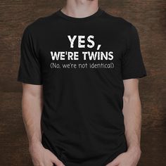 a man wearing a t - shirt that says yes, we're twins no, we're not identical