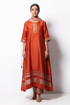 Rust orange kurta highlighted with zardozi embroidery, round neckline and straight silhouette. Comes with cotton silk pant, chanderi dupatta and inner slip.
Component: 4
Pattern: Embroidered
Type Of Work: Zardozi
Neckline: Round
Sleeve Type: Three Quarter
Fabric: Kurta: Handwoven Chanderi Silk; Dupatta: Chanderi; Pant: Cotton Silk
Color: Orange
Other Details: 
Straight kurta
Concealed placket
Side pockets
Asymmetric hem
Contrast hem pant
Dupatta with tassels
Occasion: Mehendi and Haldi, Puja - A Silk Kurta Set, Kurta Pants, Embroidery Kurta, Chanderi Dupatta, Zardozi Embroidery, Silk Pant, Cotton Kurti Designs, A Line Kurta, Kurta Designs Women