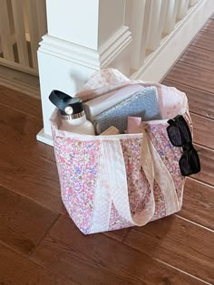 a purse sitting on top of a hard wood floor next to a bannister