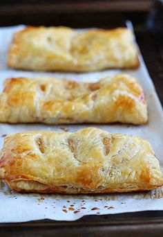 three pastries sitting on top of a baking sheet