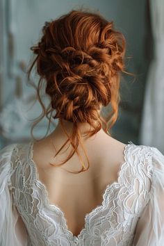 the back of a woman's head with red hair in a low updo