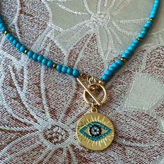 Elegant And Fashionable Eye Decor Necklace For Women Blue And Gold Color Beaded Necklace Material :Polyresin Bohemian Blue Evil Eye Jewelry, Bohemian Blue Round Beads, Blue Metal Beads For Jewelry Making, Blue Metal Beads Jewelry For Gifts, Blue Metal Beads Jewelry As Gift, Blue Beaded Necklaces For The Beach, Blue And Gold Beads For Jewelry Making, Bohemian Blue Beaded Necklaces With Evil Eye, Blue Round Beaded Necklaces For Beach