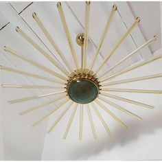 a chandelier hanging from the ceiling in a room with white walls and ceilings