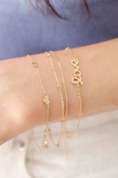 ITEM INFO Elevate your everyday style with the 14K Solid Gold Double Plain and Satellite Chain Bracelet, a stunning piece that combines minimalist beauty with contemporary flair. This bracelet features a luxurious double-chain design, consisting of one sleek plain chain and a satellite chain adorned with delicate gold beads. Crafted from high-quality 14K solid gold, this bracelet adds a touch of sophistication and sparkle to any outfit, whether worn alone or layered with other pieces. Its elegan Minimalist 14k Gold Double Chain Jewelry, Modern Double Chain Bracelet As Gift, Elegant Double Strand Bracelet With Delicate Chain, Elegant Bracelet With Adjustable Chain For Layering, Elegant Bracelets With Adjustable Chain For Layering, Modern Delicate Chain Bracelet Gift, Elegant Gold Bracelet For Layering, Elegant Adjustable Chain Bracelet For Layering, Modern Double Chain Bracelet For Everyday