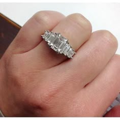 a woman's hand with a diamond ring on it