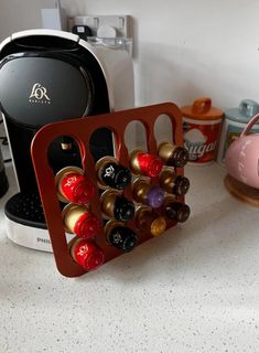 there is a coffee maker and several cups on the counter