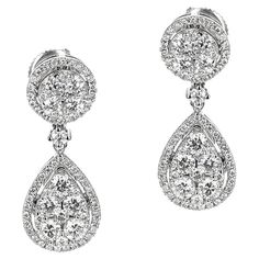 A pair of Round Diamond in Circular and Pear Shape Dangling Earrings made in 14 Karat White Gold. The total weight of the earrings is 4.19 grams. The appx. weight of the diamonds is 1.75 carats. Luxury Hallmarked Pear-shaped Diamond Earrings, Fine Jewelry Pear-shaped Diamond Earrings For Pierced Ears, Formal Pear-shaped Brilliant Cut Cluster Earrings, Pear-shaped Diamond Earrings For Pierced Ears, Timeless Diamond Cut Pear-shaped Earrings, Classic Hallmarked Pear-shaped Diamond Earrings, Pear-shaped Diamond Earrings With 17 Jewels, Formal Round Teardrop Earrings With Prong Setting, Hallmarked Pear-shaped Earrings For Wedding