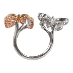 This Van Cleef & Arpels two butterfly "between the finger" ring features 18K rose gold, rhodium plated white gold, and 34 round pink sapphires diamonds of 0.88 carat each, and 36 white gold marquise-cut diamonds that are 0.99 carat each. Origin: FranceCondition: Pre-owned; Excellent - moderate Scratching to back of ringAccompanied by: VCA green jewelry box and authenticity card Measurements: Ring Size: 52 | US Size: 6 Luxury Butterfly Ring For Formal Occasions, Luxury Diamond Butterfly Ring For Formal Occasions, Formal Brilliant Cut Butterfly Ring, Luxury Butterfly Ring With Diamond Accents For Formal Occasions, Luxury Formal Butterfly Ring With Diamond Accents, Formal Butterfly Ring With Vvs Clarity, Formal Diamond Butterfly Ring In Fine Jewelry Style, Formal Diamond Butterfly Ring Fine Jewelry, Elegant Round Butterfly Ring For Formal Occasions